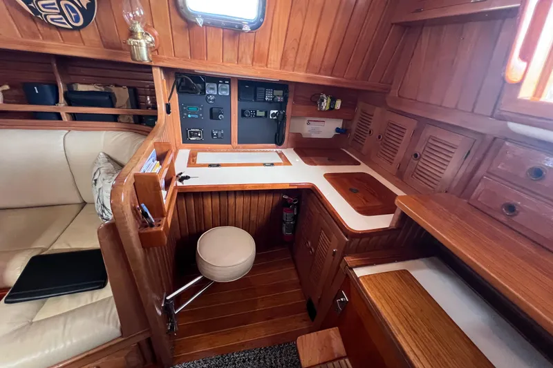 Slide: The Image of Cozy 1990 Cabo Rico 38R yacht interior with wooden cabinetry and navigation station. - 29