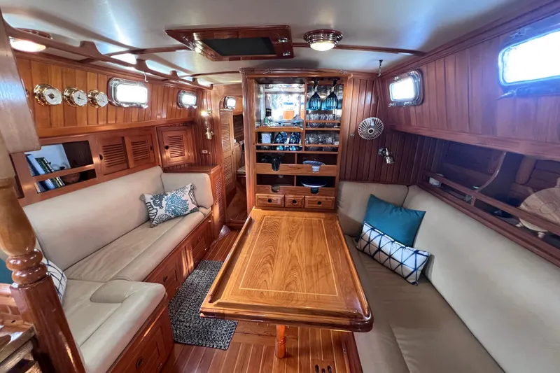 Slide: The Image of Luxurious 1990 Cabo Rico 38R yacht interior with elegant wood finish and cozy seating. - 3