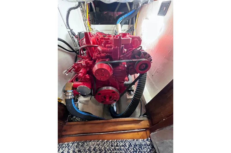 Slide: The Image of Red engine inside a 1990 Cabo Rico 38R sailboat, showcasing detailed mechanical components. - 31