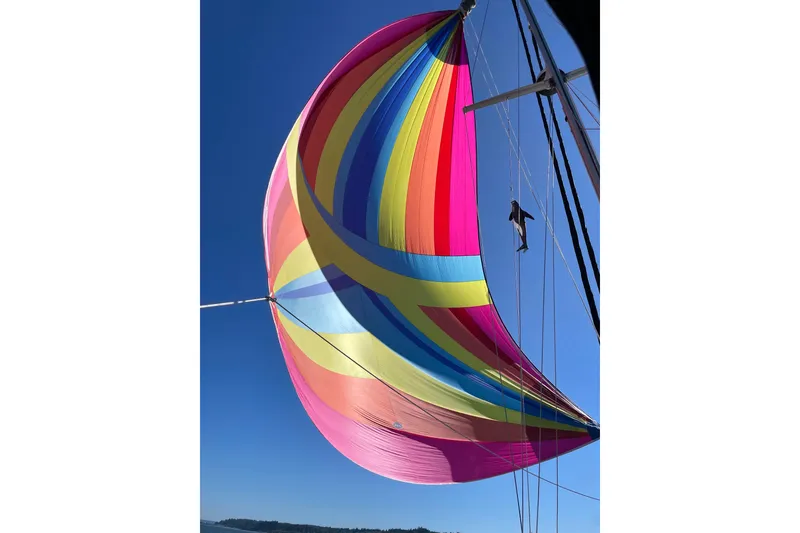 Slide: The Image of Colorful spinnaker sail on 1990 Cabo Rico 38R yacht against clear blue sky. - 34