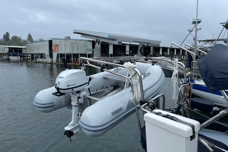 Slide: The Image of Inflatable dinghy with Tohatsu motor on Cabo Rico 38R, 1990, docked at marina. - 35