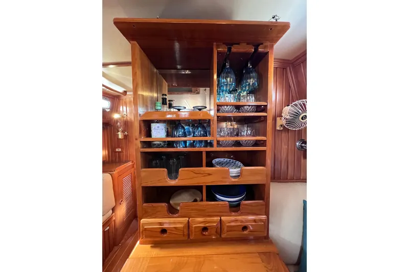 Slide: The Image of Wooden cabinet with glassware and dishes on a 1990 Cabo Rico 38R yacht. - 5