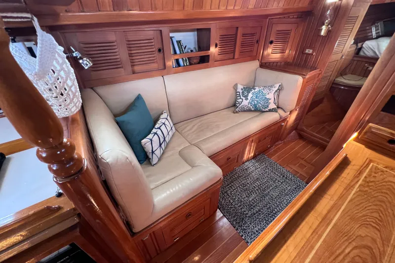 Slide: The Image of Luxurious 1990 Cabo Rico 38R yacht interior with cozy seating and elegant wood finish. - 8