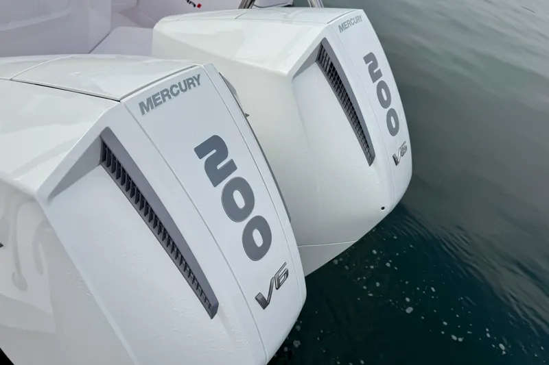 Slide: The Image of Twin Mercury 200 V6 engines on a 2023 Axopar 28 Cabin boat, floating on water. - 29