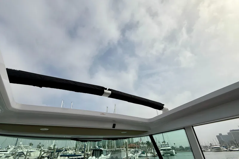 Slide: The Image of 2023 Axopar 28 Cabin boat interior view with marina background. - 31