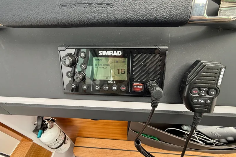 Slide: The Image of Simrad radio system on 2023 Axopar 28 Cabin boat dashboard. - 35