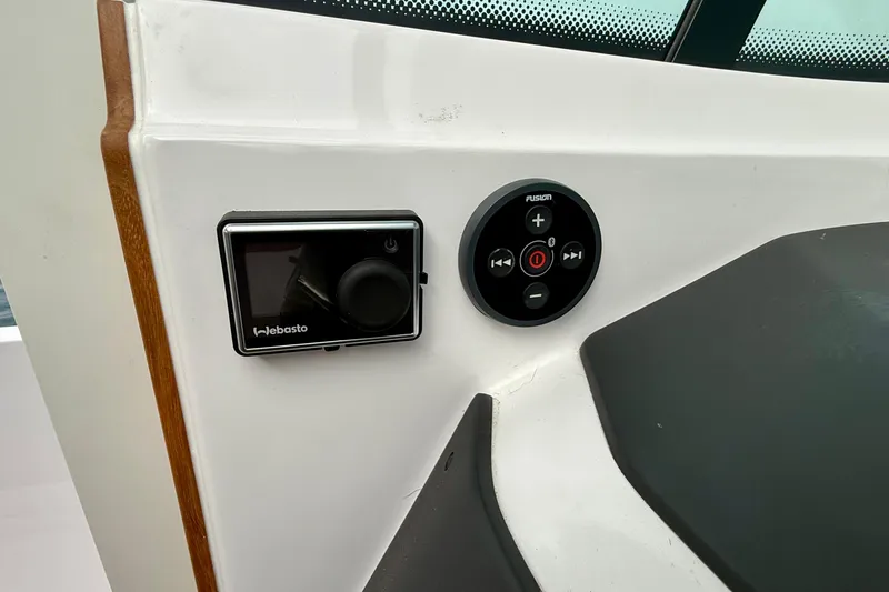 Slide: The Image of Control panel on 2023 Axopar 28 Cabin boat featuring Webasto and Fusion systems. - 36