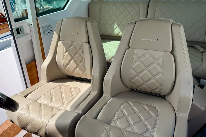 Slide: The Image of Luxurious beige leather seats in 2023 Axopar 28 Cabin boat interior. - 37