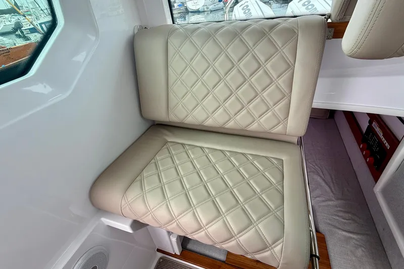 Slide: The Image of Luxurious beige seating in 2023 Axopar 28 Cabin boat interior. - 39