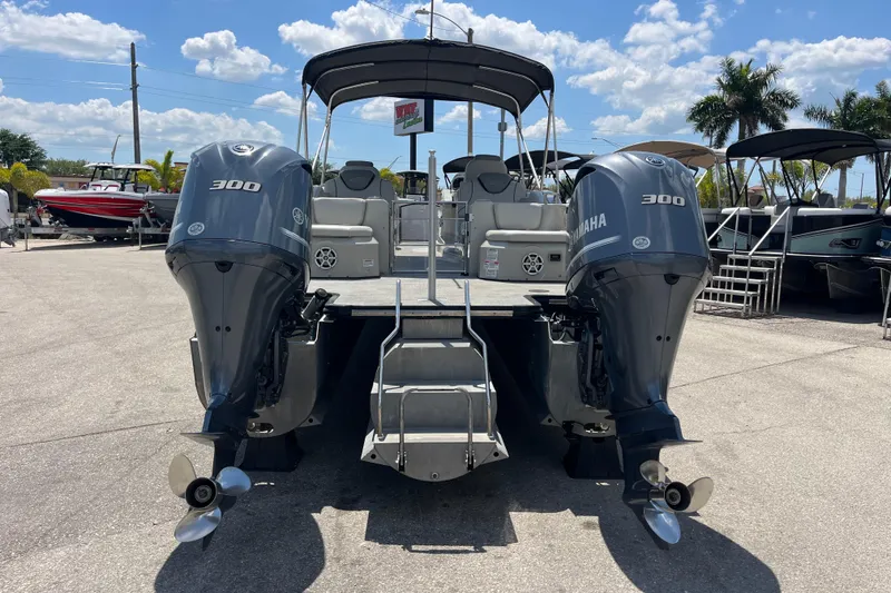 Slide: The Image of 2017 Sylvan Mandalay 8525 Sportlounger Twin with dual Yamaha 300 engines, docked under sunny skies. - 5