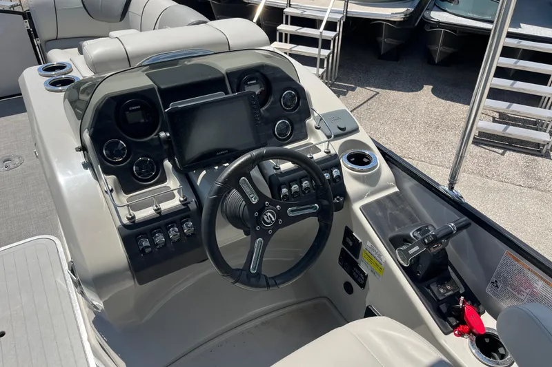 Slide: The Image of 2017 Sylvan Mandalay 8525 Sportlounger Twin boat dashboard with steering wheel and controls. - 11