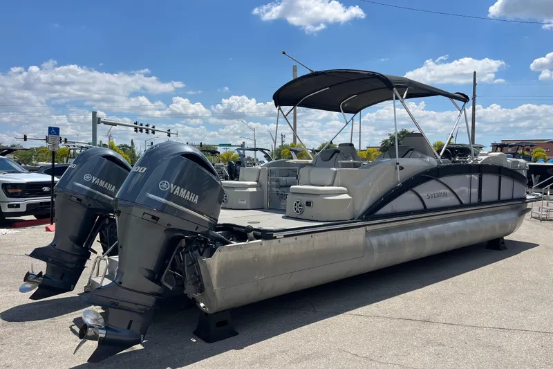 Slide: The Image of 2017 Sylvan Mandalay 8525 Sportlounger Twin pontoon boat with Yamaha engines displayed outdoors. - 4