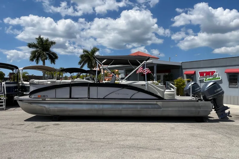 Slide: The Image of 2017 Sylvan Mandalay 8525 Sportlounger Twin pontoon boat with dual Yamaha engines, parked outdoors. - 7