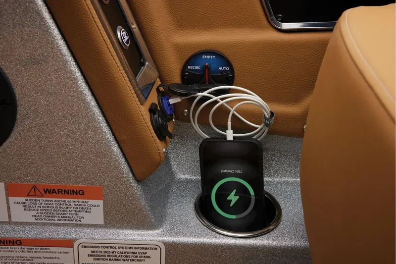 Slide: The Image of Manufacturer Provided Image: Charging phone in 2026 Ranger Z520R Ultra boat console with warning labels. - 41