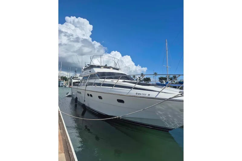 The Image of Horizon 1992 power boat docked under a clear blue sky. - 1
