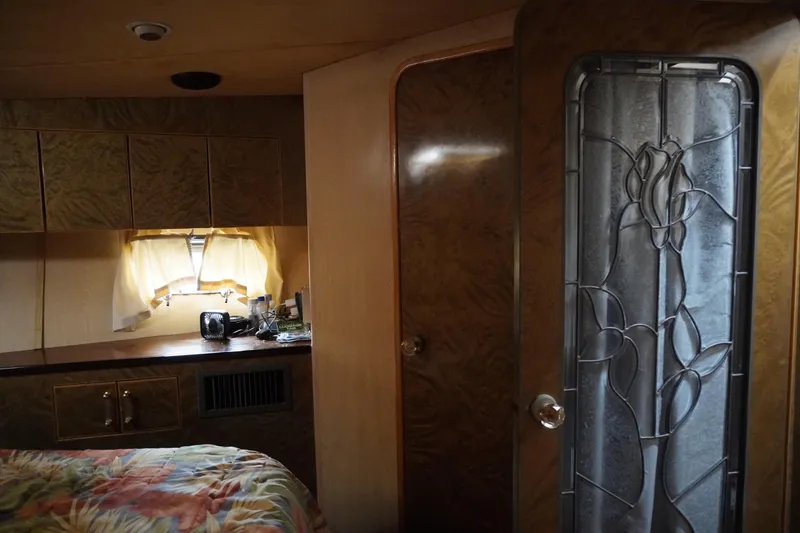 Slide: The Image of Interior of 1992 Horizon Power Boat with decorative glass door and cozy cabin space. - 10