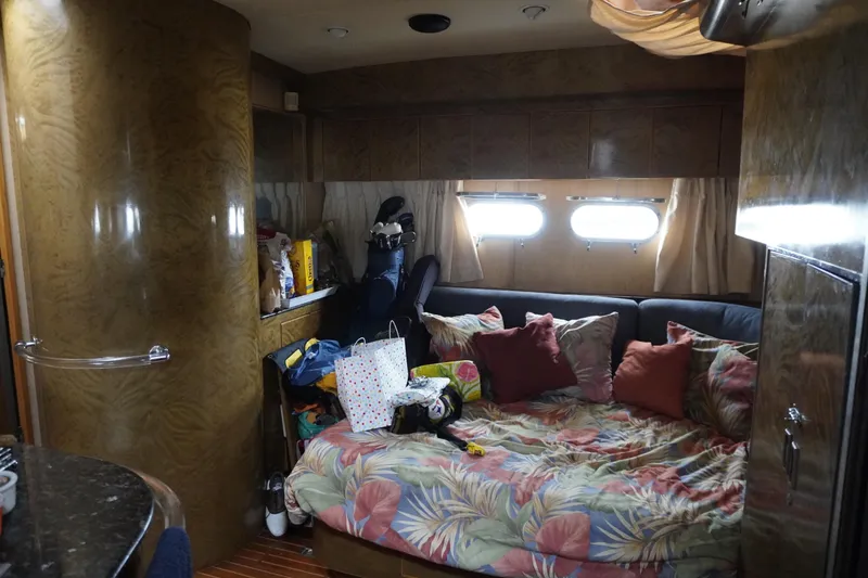 Slide: The Image of Interior of a 1992 Horizon Power Boat with cozy bedding and storage. - 16