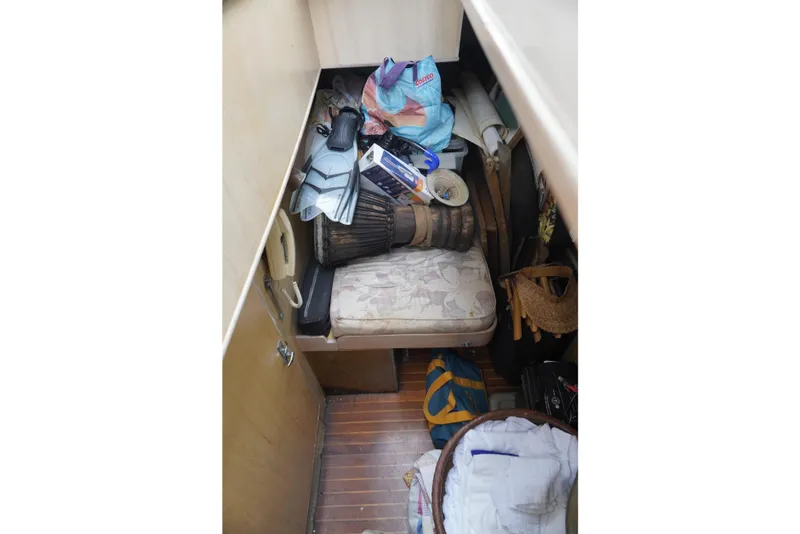 Slide: The Image of Interior of a 1992 Horizon Power Boat with cluttered storage area. - 20