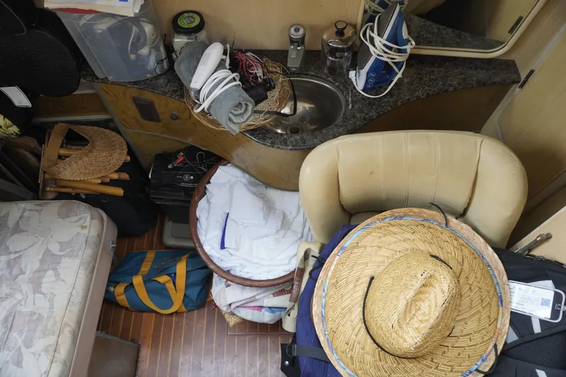 Slide: The Image of Interior of a 1992 Horizon power boat with various items and a straw hat. - 21