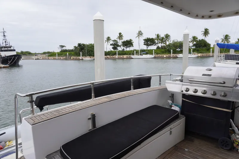 Slide: The Image of 1992 Horizon Power Boat with grill, docked near palm trees and calm waters. - 22