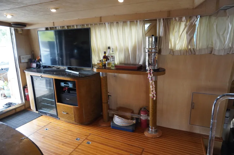 Slide: The Image of Interior of 1992 Horizon Power Boat with TV, bar, and wooden flooring. - 23