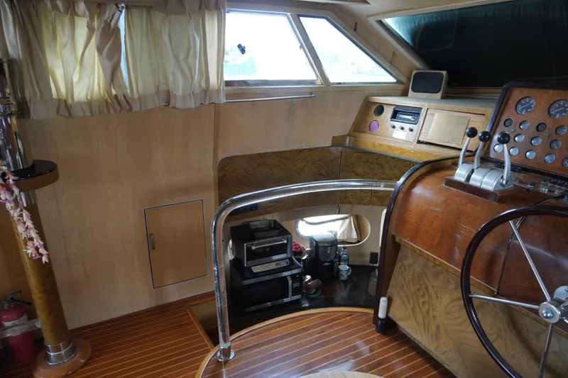 Slide: The Image of Interior of a 1992 Horizon power boat with wooden helm and navigation instruments. - 24