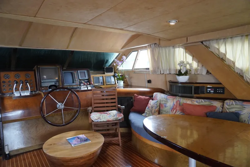 Slide: The Image of Interior of a 1992 Horizon power boat with wooden decor and floral seating. - 25