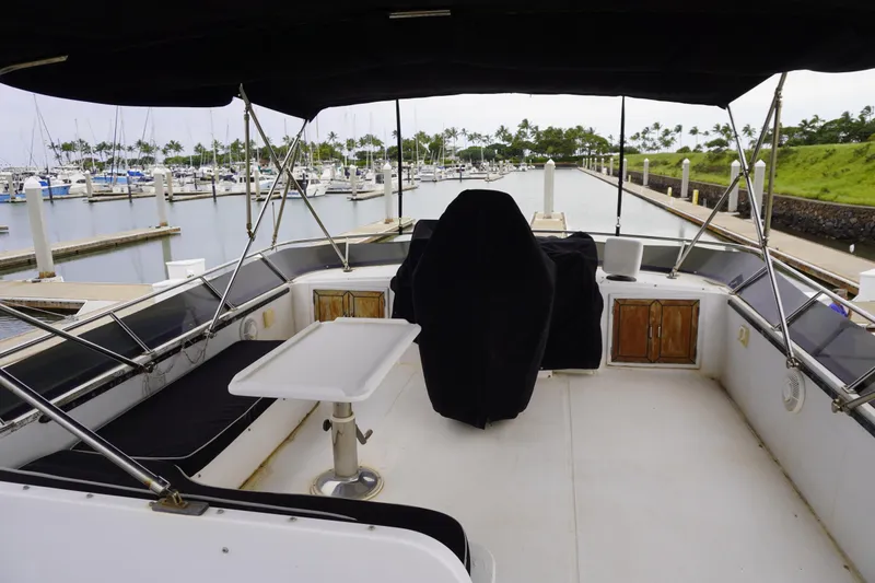 Slide: The Image of 1992 Horizon power boat interior with seating and table at marina dock. - 32