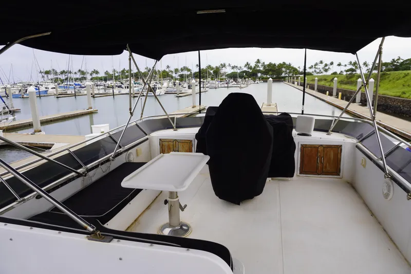 Slide: The Image of 1992 Horizon Power Boat interior with covered seating, table, and marina view. - 33