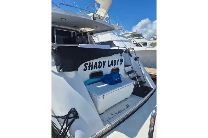 Slide: The Image of 1992 Horizon power boat named "Shady Lady" docked under clear blue sky. - 5