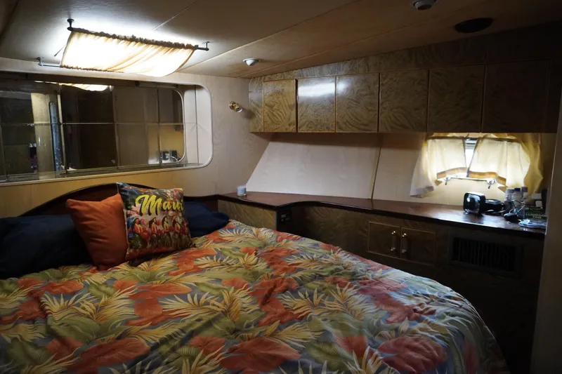 Slide: The Image of Cozy 1992 Horizon Power Boat cabin with tropical bedding and decorative pillows. - 8