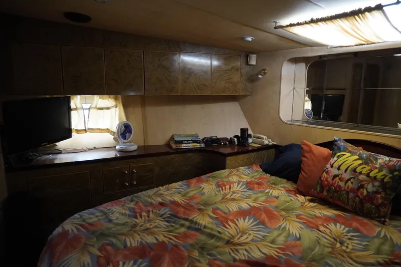 Slide: The Image of Cozy cabin interior of 1992 Horizon Power Boat with floral bedding and wooden cabinets. - 9