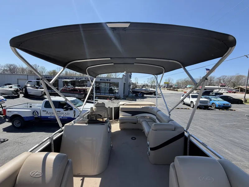 Slide: The Image of 2013 Harris Cruiser 240 pontoon boat with canopy on parking lot. - 13