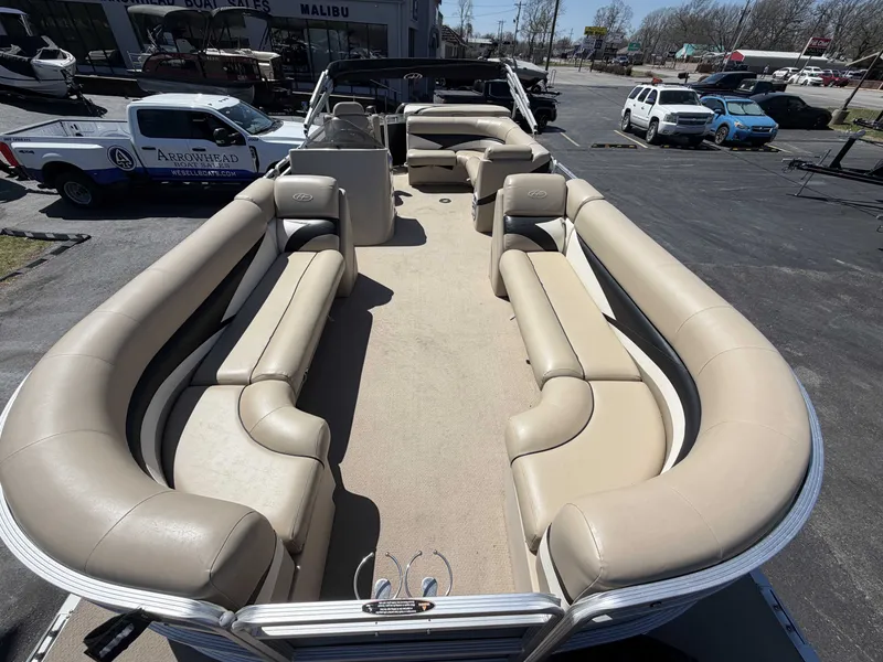 Slide: The Image of 2013 Harris Cruiser 240 pontoon boat with beige seating on a parking lot. - 15