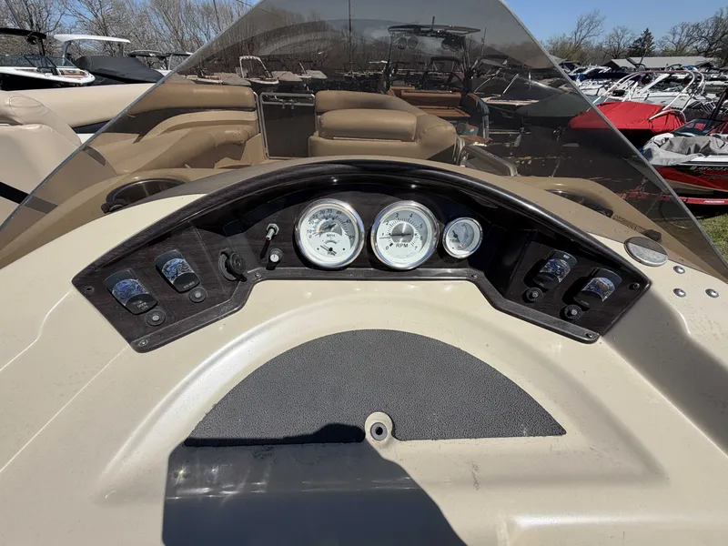 Slide: The Image of Dashboard of a 2013 Harris Cruiser 240 boat with gauges. - 16