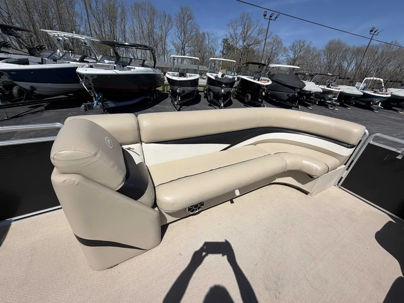 Slide: The Image of 2013 Harris Cruiser 240 pontoon boat with beige seating area outdoors. - 8