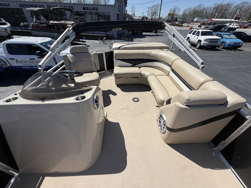 Slide: The Image of 2013 Harris Cruiser 240 pontoon boat with beige seating and helm. - 9