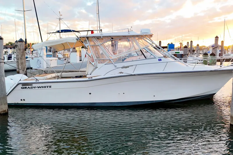 The Image of 2006 Grady-White Express 330 boat docked at marina during sunset. - 0
