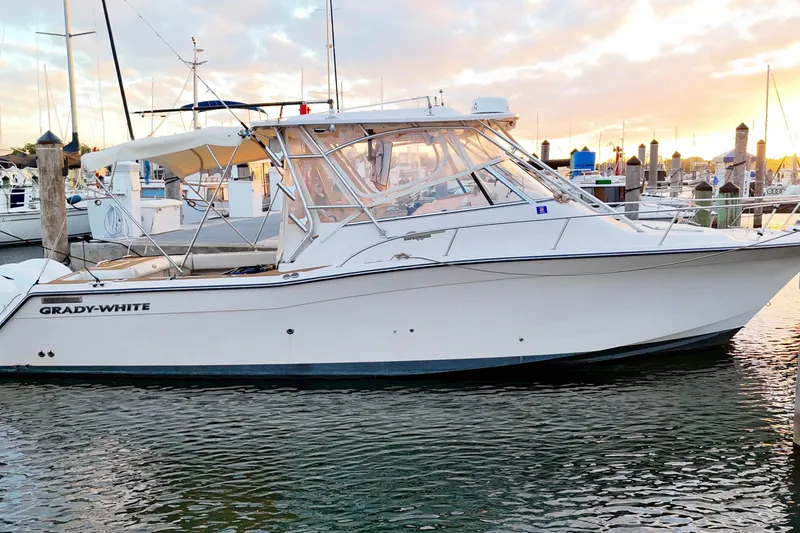 Slide: The Image of 2006 Grady-White Express 330 boat docked at marina during sunset. - 1