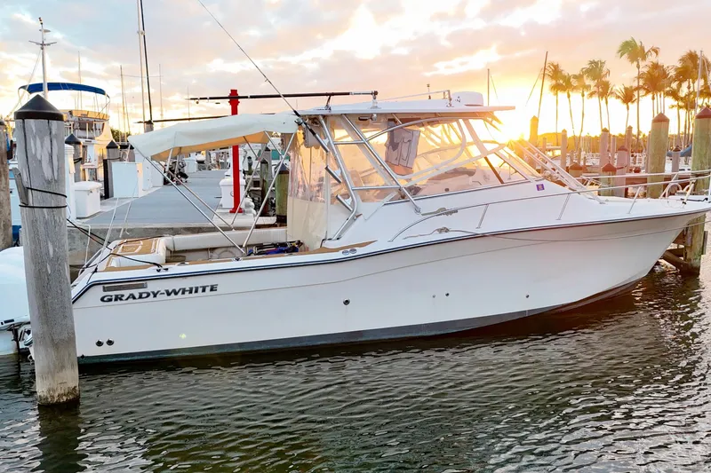 Slide: The Image of 2006 Grady-White Express 330 boat docked at marina during sunset. - 11