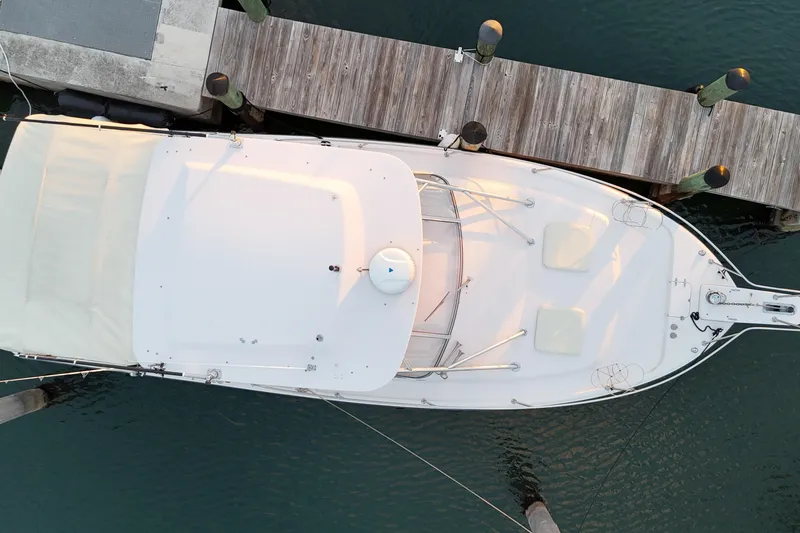 Slide: The Image of Aerial view of 2006 Grady-White Express 330 boat docked at a wooden pier. - 18