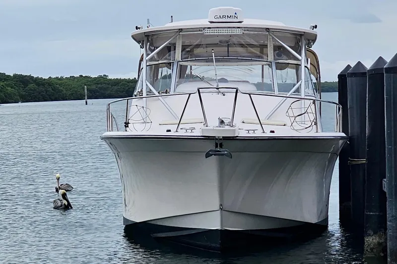 Slide: The Image of 2006 Grady-White Express 330 boat docked, with pelicans nearby in calm waters. - 22