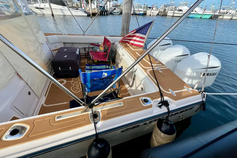 Slide: The Image of 2006 Grady-White Express 330 boat docked, featuring Yamaha engines and American flag. - 24