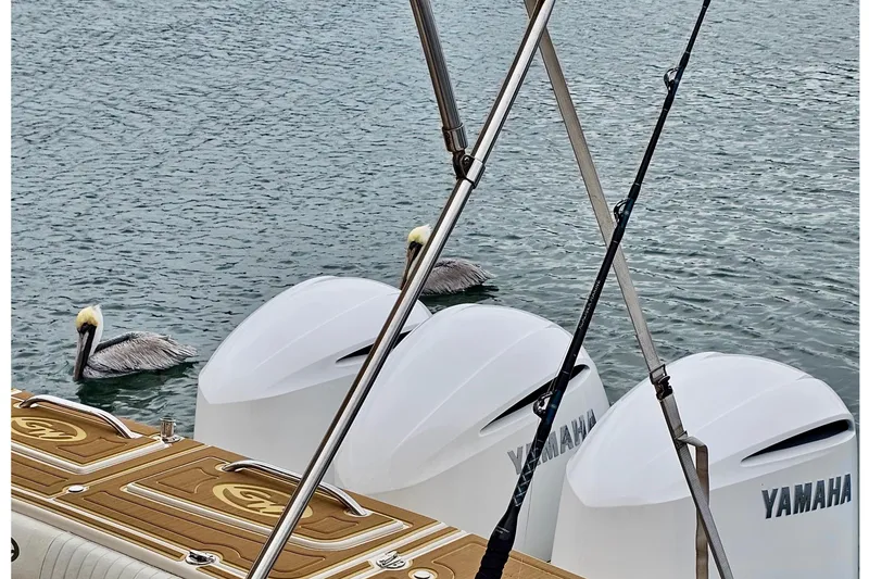 Slide: The Image of 2006 Grady-White Express 330 boat with Yamaha engines and pelicans in water. - 26