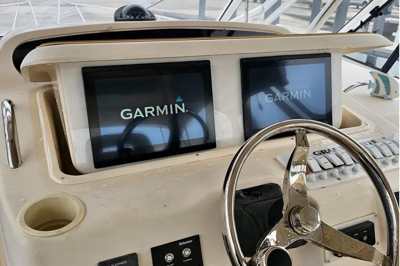 Slide: The Image of Dashboard of a 2006 Grady-White Express 330 boat with dual Garmin displays. - 28