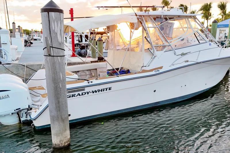 Slide: The Image of 2006 Grady-White Express 330 boat docked at marina during sunset. - 3