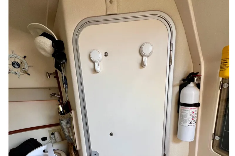 Slide: The Image of Interior of a 2006 Grady-White Express 330 boat with door and fire extinguisher. - 34