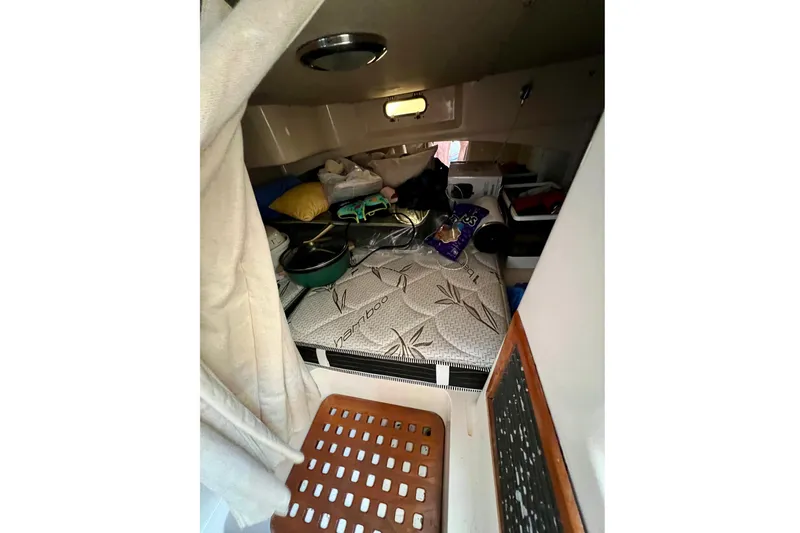 Slide: The Image of 2006 Grady-White Express 330 cabin interior with mattress and assorted items. - 35