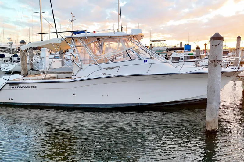 Slide: The Image of 2006 Grady-White Express 330 boat docked at marina during sunset. - 4