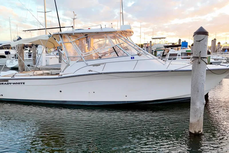 Slide: The Image of 2006 Grady-White Express 330 boat docked at marina during sunset. - 5
